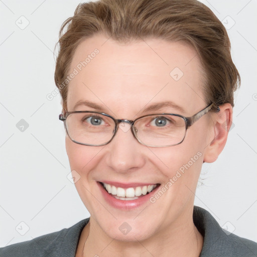 Joyful white adult female with short  brown hair and blue eyes