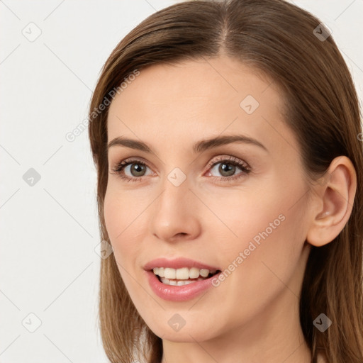 Joyful white young-adult female with long  brown hair and grey eyes