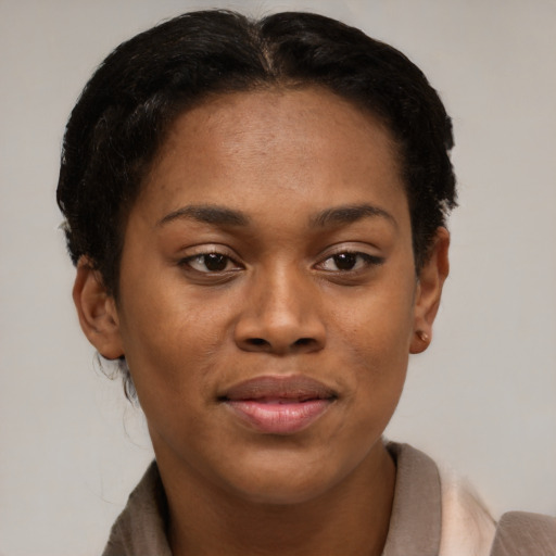 Joyful black young-adult female with short  brown hair and brown eyes
