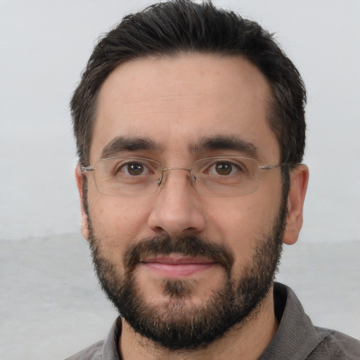 Joyful white adult male with short  brown hair and brown eyes