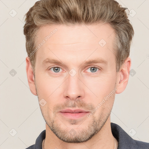 Joyful white adult male with short  brown hair and grey eyes