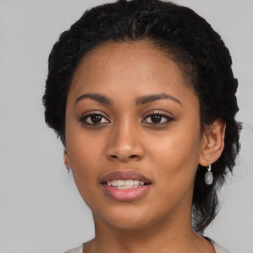 Joyful latino young-adult female with short  black hair and brown eyes