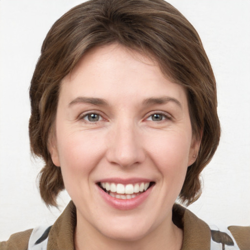 Joyful white young-adult female with medium  brown hair and grey eyes