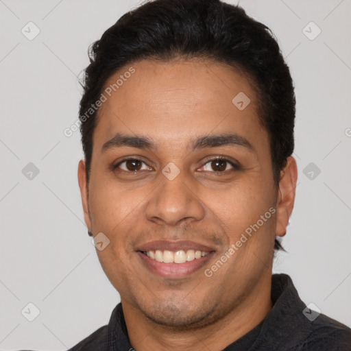 Joyful latino young-adult male with short  black hair and brown eyes