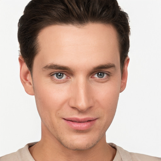 Joyful white young-adult male with short  brown hair and brown eyes