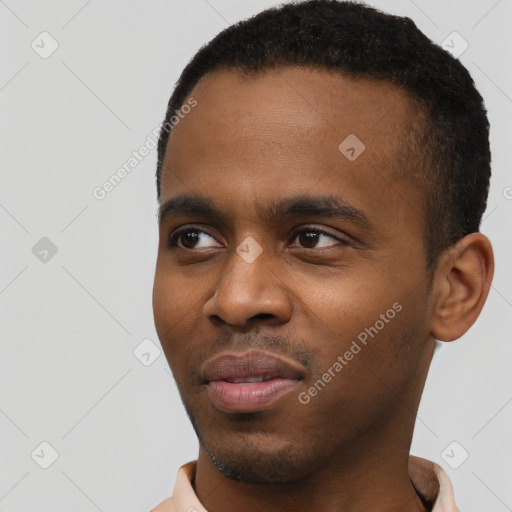 Joyful black young-adult male with short  black hair and brown eyes