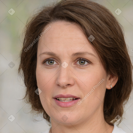 Joyful white adult female with medium  brown hair and green eyes