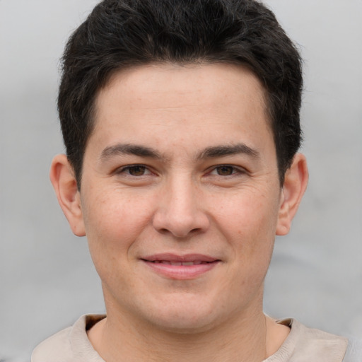 Joyful white young-adult male with short  brown hair and brown eyes