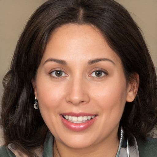 Joyful white adult female with medium  brown hair and brown eyes