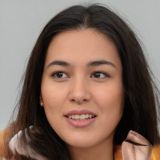 Joyful asian young-adult female with long  brown hair and brown eyes