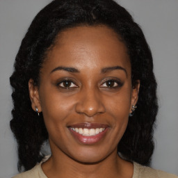 Joyful black young-adult female with medium  brown hair and brown eyes