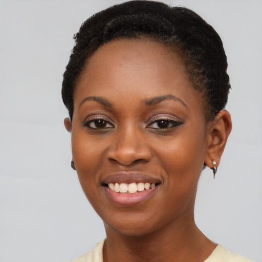 Joyful black young-adult female with short  brown hair and brown eyes