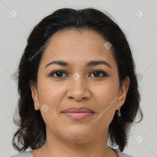 Joyful latino young-adult female with medium  brown hair and brown eyes