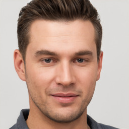 Joyful white young-adult male with short  brown hair and brown eyes