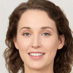 Joyful white young-adult female with medium  brown hair and green eyes