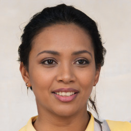 Joyful latino young-adult female with short  brown hair and brown eyes