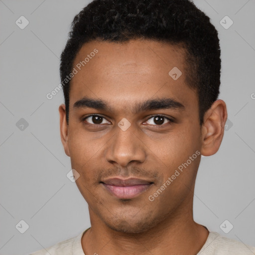 Joyful black young-adult male with short  black hair and brown eyes