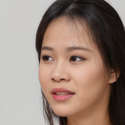 Joyful asian young-adult female with long  brown hair and brown eyes