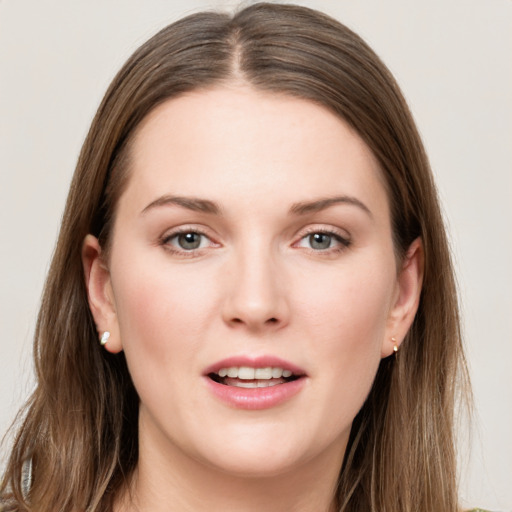 Joyful white young-adult female with long  brown hair and grey eyes