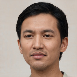 Joyful asian adult male with short  black hair and brown eyes