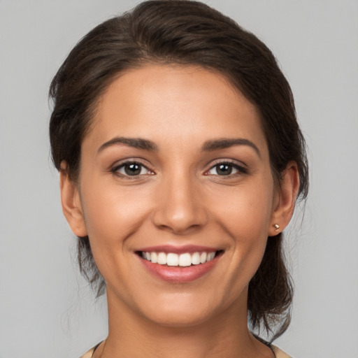 Joyful white young-adult female with medium  brown hair and brown eyes