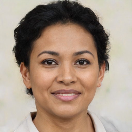 Joyful latino young-adult female with short  brown hair and brown eyes