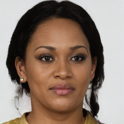 Joyful black young-adult female with medium  brown hair and brown eyes