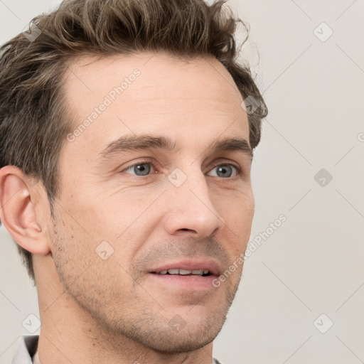 Joyful white adult male with short  brown hair and grey eyes