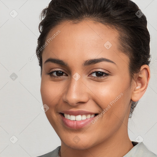 Joyful white young-adult female with short  brown hair and brown eyes