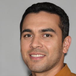Joyful white young-adult male with short  black hair and brown eyes