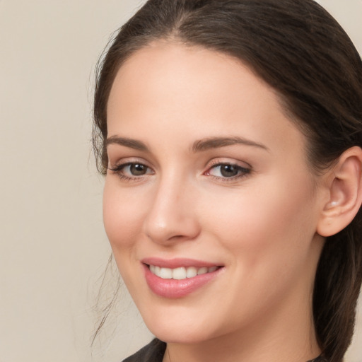 Joyful white young-adult female with long  brown hair and brown eyes