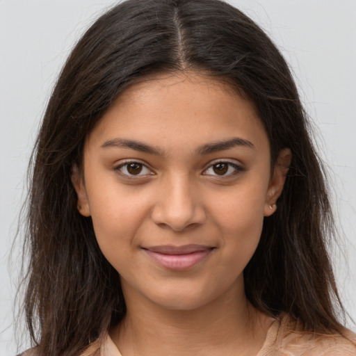 Joyful latino young-adult female with long  brown hair and brown eyes