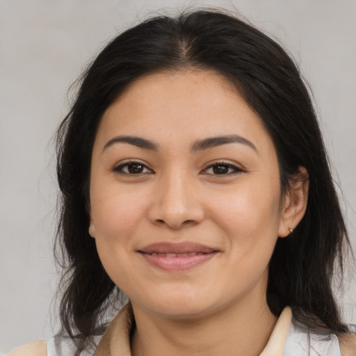 Joyful latino young-adult female with medium  brown hair and brown eyes