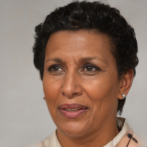 Joyful latino adult female with short  brown hair and brown eyes