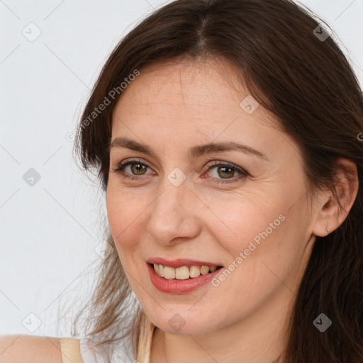 Joyful white adult female with long  brown hair and brown eyes