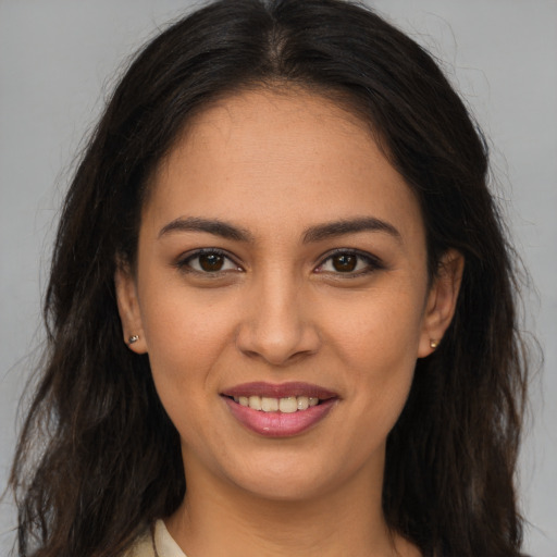 Joyful white young-adult female with long  brown hair and brown eyes