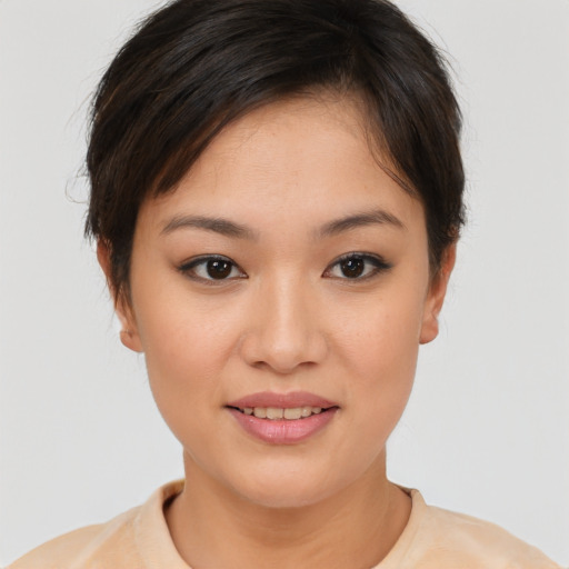 Joyful asian young-adult female with short  brown hair and brown eyes