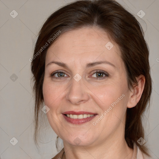 Joyful white adult female with medium  brown hair and grey eyes