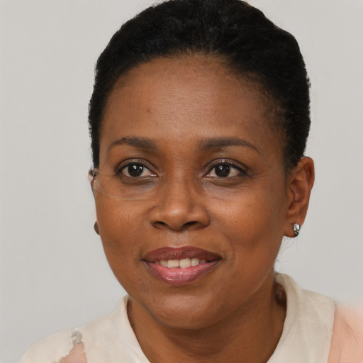 Joyful black adult female with short  black hair and brown eyes