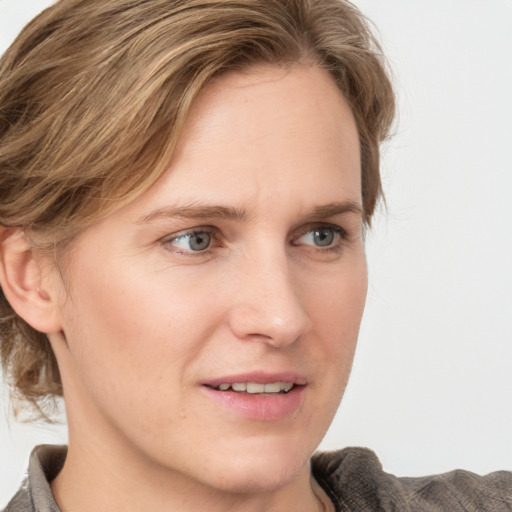 Joyful white young-adult female with medium  brown hair and blue eyes