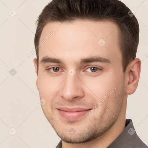 Joyful white young-adult male with short  brown hair and brown eyes