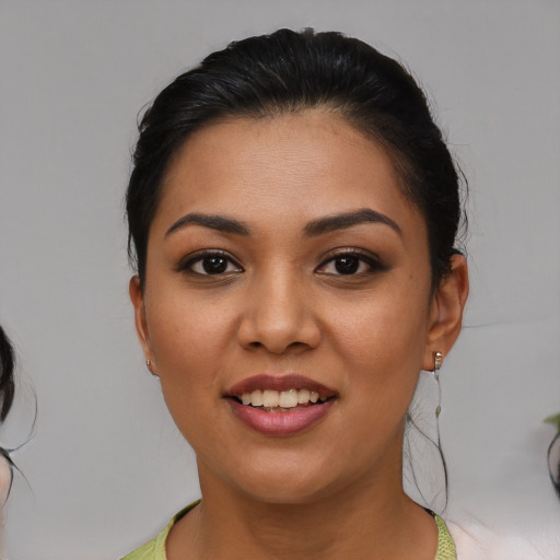 Joyful latino young-adult female with medium  brown hair and brown eyes