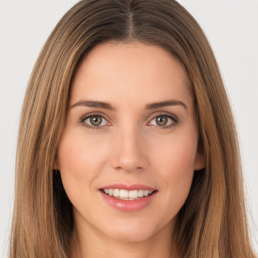 Joyful white young-adult female with long  brown hair and brown eyes