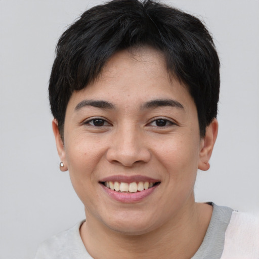 Joyful asian young-adult female with short  brown hair and brown eyes