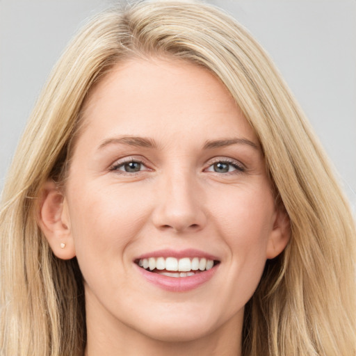 Joyful white young-adult female with long  brown hair and blue eyes