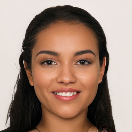 Joyful latino young-adult female with long  black hair and brown eyes