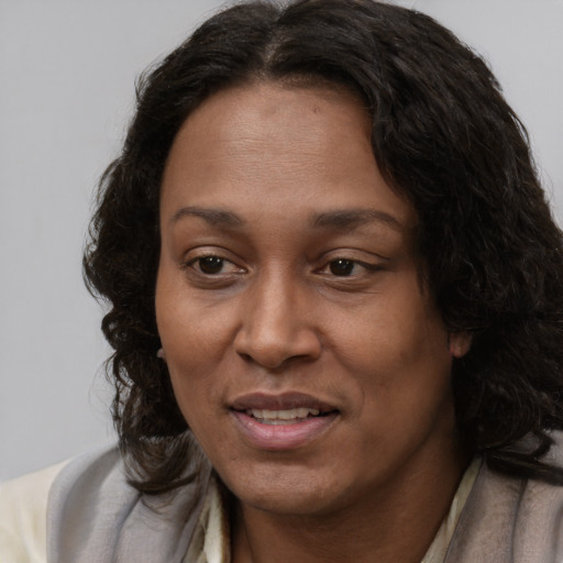 Joyful latino adult female with long  brown hair and brown eyes