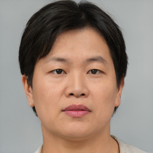 Neutral asian adult female with short  brown hair and brown eyes