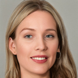 Joyful white young-adult female with long  brown hair and blue eyes