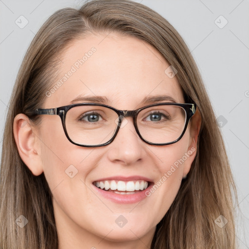 Joyful white young-adult female with long  brown hair and blue eyes